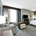 Homewood Suites by Hilton New Braunfels guest suite with king bed, sofa, TV and seating area