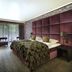 Hotel Gladbeck van der Valk room with purple upholstered bed, desk, seating area and balcony view