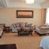Qilu International Hotel in Harbin living room suite with sofa, armchairs, coffee table and large window