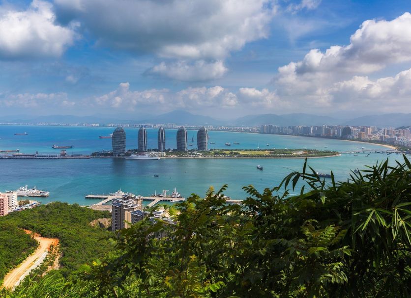 Phoenix Waterside Gloria Resort Sanya overlooking Sanya Bay and city skyline from a lush hillside