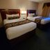 Triplodge of Santa Clarita room with two double beds and a bedside lamp in Forest Park
