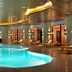 Gazelle Resort & Spa in Karacasu indoor pool with curved turquoise water and lounge chairs