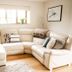 The Anchorage & The Tackleshed, Barry: bright lounge with cream sectional sofa, window bench and wall art