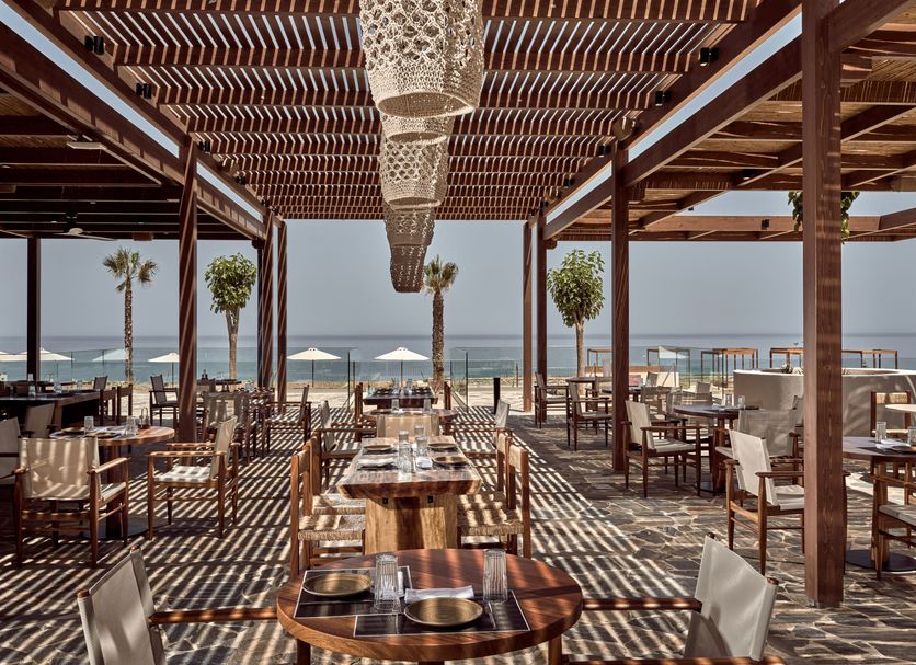 The Royal Senses Resort & Spa Crete, Curio Collection by Hilton in Panormos: beachfront restaurant with sea views