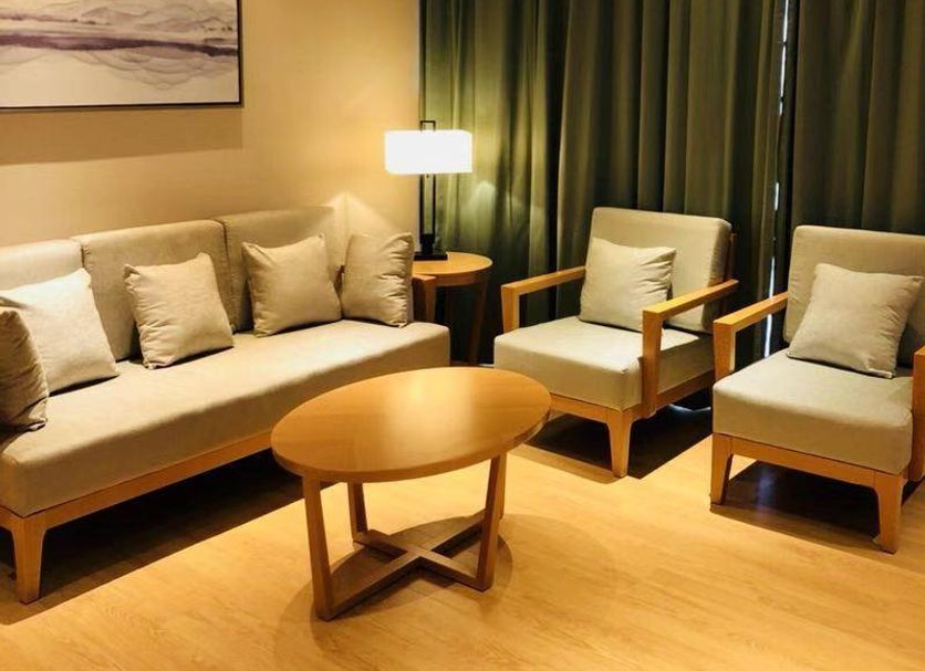 Clovelly Garden Hotel Shanghai lounge with sofa, two armchairs, coffee table and lamp