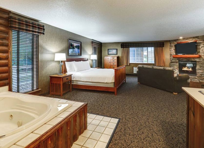 Stoney Creek Hotel St. Joseph room with whirlpool tub, king bed, fireplace, and seating area