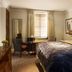 The Arden Hotel in Stratford-upon-Avon guest room with king bed, seating area and window blinds