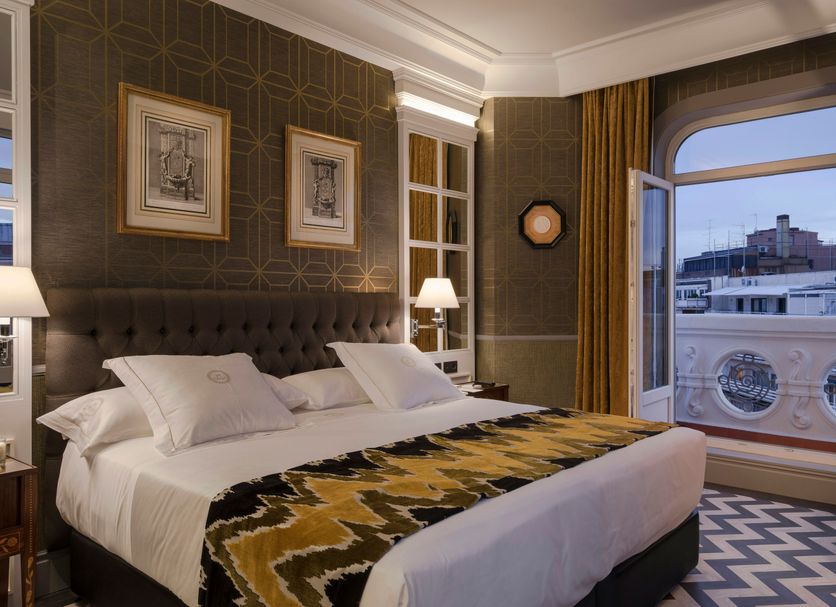 Relais & Châteaux Heritage Hotel Madrid guest room with king bed and city-view window