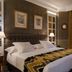 Relais & Châteaux Heritage Hotel Madrid guest room with king bed and city-view window