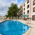 La Quinta Inn & Suites by Wyndham Bonita Springs Naples N. poolside outdoor pool with patio and hotel exterior