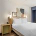 Spark by Hilton Atlanta Airport South College Park guest room with bed, desk and chair in College Park