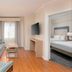 Homewood Suites by Hilton Bonita Springs Naples North room with sofa, desk and bedroom doorway