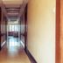 OYO 1594 Hotel Landmark, Visakhapatnam hallway with polished tile floor and bright ceiling lights