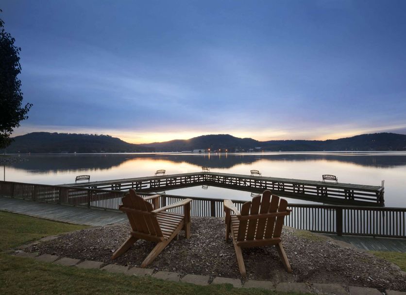 Wyndham Garden Lake Guntersville lakeside deck with adirondack chairs overlooking the lake at dusk