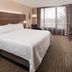 Holiday Inn Express Boca Raton-West guest room with king bed, desk, TV, and window seating area