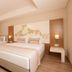 Venosa Beach Resort And Spa Didim guest room with king bed, sofa, and large window