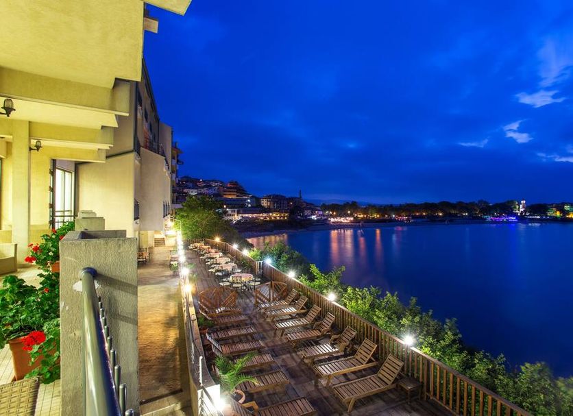 Hotel Antea - By The Sea in Sozopol with balcony seating overlooking the sea at dusk