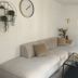 Altstadt-Hotel Gosequell Goslar lounge with beige sectional, glass coffee table, wall clock and floral wall art