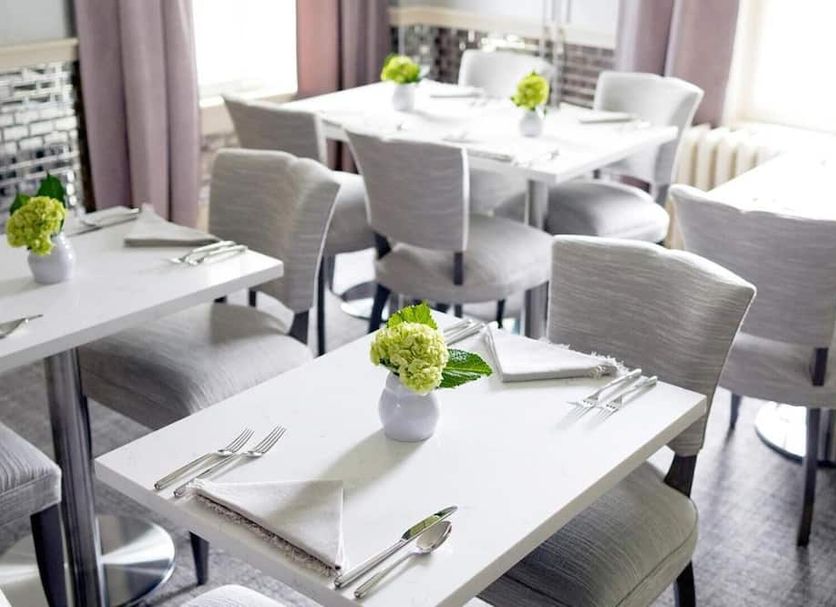 33 Main in Lenox dining room with white tables, gray chairs, and bright window seating