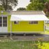 Del Garda Village and Camping in Peschiera del Garda, bright yellow mobile home with awning among trees