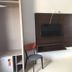 Atlas Hotel - Centro in Palmas: wall-mounted TV, chair, open closet and full-length mirror