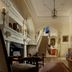 Crossbasket Castle Glasgow grand hallway with staircase, ornate fireplace, chandelier and antique furnishings