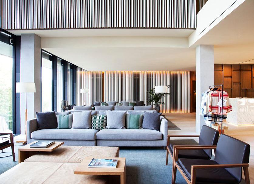 Hotel Arima & Spa in San Sebastian lobby with gray sofa, lounge chairs and modern wood accents