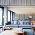 Hotel Arima & Spa in San Sebastian lobby with gray sofa, lounge chairs and modern wood accents