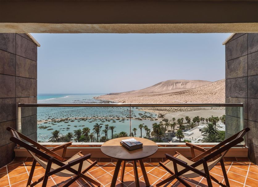 Paradisus Fuerteventura balcony with seating and table overlooking Pájara beach and ocean