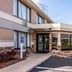 Quality Inn Pensacola North exterior entrance with glass doors and stone-trimmed facade in Pensacola