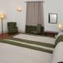 Monte Dos Apóstolos in Portalegre, guest room with twin beds, armchairs, lamps and curtained window
