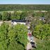 Backby Manor, Espoo: aerial view of manor buildings, parking area, and surrounding green forest