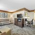 Best Western Black Hills Lodge in Spearfish living area with sofa, TV, desk and patterned carpet