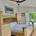 The Villas on Lake George bedroom with king bed and balcony overlooking trees in Diamond Point