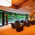 Anda Bettei Izu Ippekiko Resort in Itō lounge with chairs, tables, and large windows to greenery
