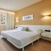 Protur Badia Park Aparthotel guest room in Sa Coma with twin beds and window curtains