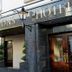 Dillons Hotel in Letterkenny entrance with gold signage, dark stone facade, and wooden doors