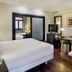 Sercotel Puerta de la Catedral room in Salamanca with bed, sofa bed, TV and desk