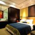 Haobo International Hotel in Wuxi guest room with king bed, bedside lamp, and lounge chair