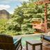 Aqua Oceanfront Hotel Resort in El Gigante with wooden terrace, chairs, pool, and mountain ocean view