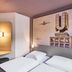 B&b Hotel Dortmund-Airport in Unna guest room with twin beds and airport-themed wall art