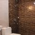 OYO 9618 Home 2 Bhk Vasco South Goa bathroom with toilet and brown marble-pattern shower walls in Mandrem