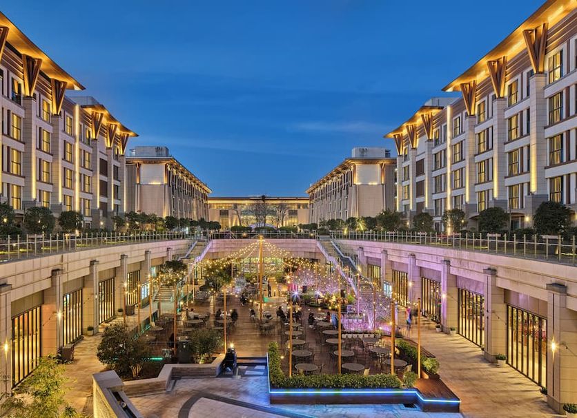 Landing Jeju Shinhwa World Hotels & Resorts in Seogwipo, illuminated courtyard between twin hotel wings