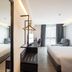 Travelodge Phuket Town in Phuket City guest room with two beds, mirror, desk and window seating