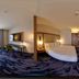 Fairfield by Marriott Inn & Suites Milwaukee Brookfield guest room with king bed and wall-mounted TV in Brookfield