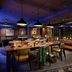 Moxy Asheville Downtown in Asheville lobby lounge with long communal table, leather sofa, and city views