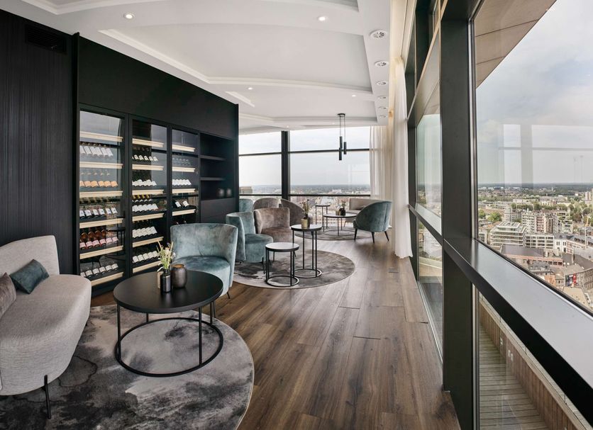 Radisson Blu Hotel, Hasselt lounge with city-view windows and seating area in Hasselt