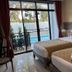 Radateeree Boutique Resort, Chiang Mai: twin beds beside a sliding glass door to a poolside patio