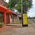 Hosteria Maryland in Posadas storefront entrance with orange facade and sidewalk view