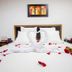 Travelers Orange Cartagena bed with swan towel art, rose petals and roses in Cartagena